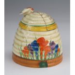 Clarice Cliff Bizarre Crocus pattern beehive honey pot, circa 1930, lid repaired, height 9.5cm