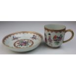 Embossed painted hand-decorated porcelain cup and saucer featuring coat of arms.