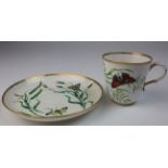 English(?) porcelain cup and saucer decorated with grass and butterflies.