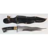 Knife: A large sheath knife with 10" wavy 'KRIS' type blade. Canvas ebony grip with animal head