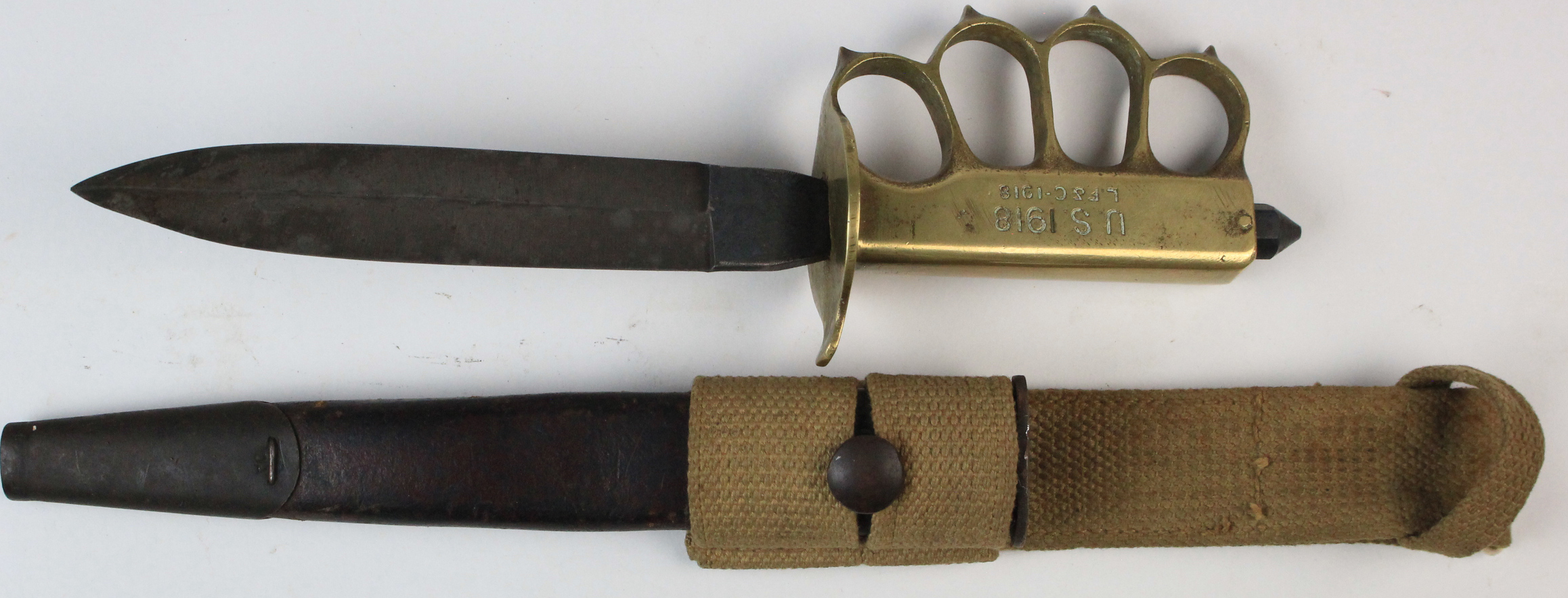 A scarce U.S. WW1 MKI Trench Knuckle Duster fighting knife. Brass grip and knuckles stamped 'U.S.