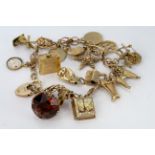 9ct Gold Charm Bracelet with numerous Charms plus two loose charms weight 44.6g
