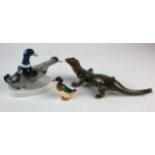 Three porcelain figures comprising a green glazed lizard, a pair of ducks and a smaller individual