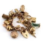 9ct charm bracelet with a large selection of charms attached. Total weight 79.5g