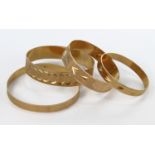 Four Yellow metal (test 18ct) patterned Gold bangles weight 66.3g