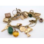 9ct / Yellow metal charm bracelet with a small selection of charms attached, approx total weight