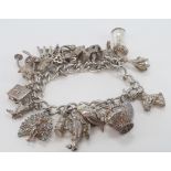 Silver charm bracelet with a good variety of charms attached. Total weight approx 66.9g