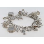 Silver charm bracelet with a good variety of charms attached. Total weight approx 86.6g