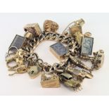 Heavy 9ct / yellow metal charm bracelet with a good selection of charms attached to include £20, £