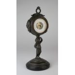 Aneroid open face barometer on putto stand, circa 1875, barometer diameter 5.5cm, total height