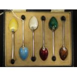 Very attractive boxed set of six enamel & silver bean top coffee spoons. The spoon with the brown