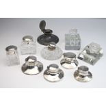 Ten desk inkwells, including silver, glass, pewter and plated examples