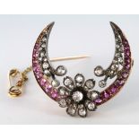 Yellow metal (tests as 9ct Gold) Diamond and Ruby set Crescent shaped Brooch with pin and safety