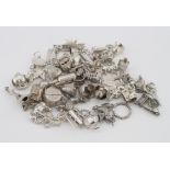 Assortment of over 40 silver / white metal charms, total weight approx 100g