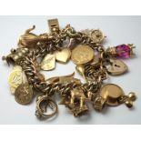 9ct / Yellow metal charm bracelet with many charms attached, approx total weight 99.2g