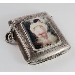 Silver engraved risque vesta case, with enamel panel to front depicting a lady showing her bare