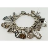 Heavy Silver / white metal charm bracelet with a large variety of charms attached, approx 110.8g