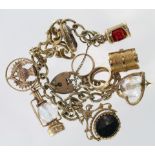 9ct charm bracelet with a selection of charms attached. Approx weight 53.2g