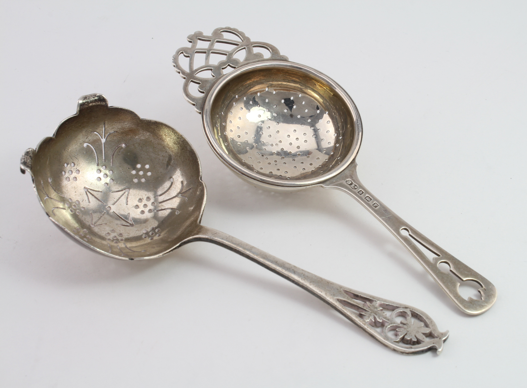 Two silver Tea Strainers hallmarked for Sheffield 1955 and Birmingham 1949. Weight 2¾ oz