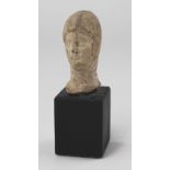 Clay? bust of youthful female, wearing hooded garment which covers the ears, c57mm. high, a nice