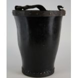 Leather fire bucket with metal studded rim, circa 19th century, leather carrying handle (detached to