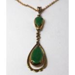 Yellow metal (tests 9ct) Jade drop pendant on a 16 inch fine chain weight 4.4g