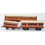 Three O gauge coaches comprising Bassett Lowke nos. 36232 & 2534 & a Bing 265, in need of some