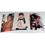 James Bond interest. Three autographed colour photographs of Roger Moore, Pierce Brosnan & George