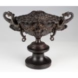 An unusual ornately decorated urn with lid, mounted on a turned wooden base, circa late 19th