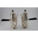 Pair of silver chocolate pots with ebonised handles and finials, hallmarked Sheffield 1929 by Cooper
