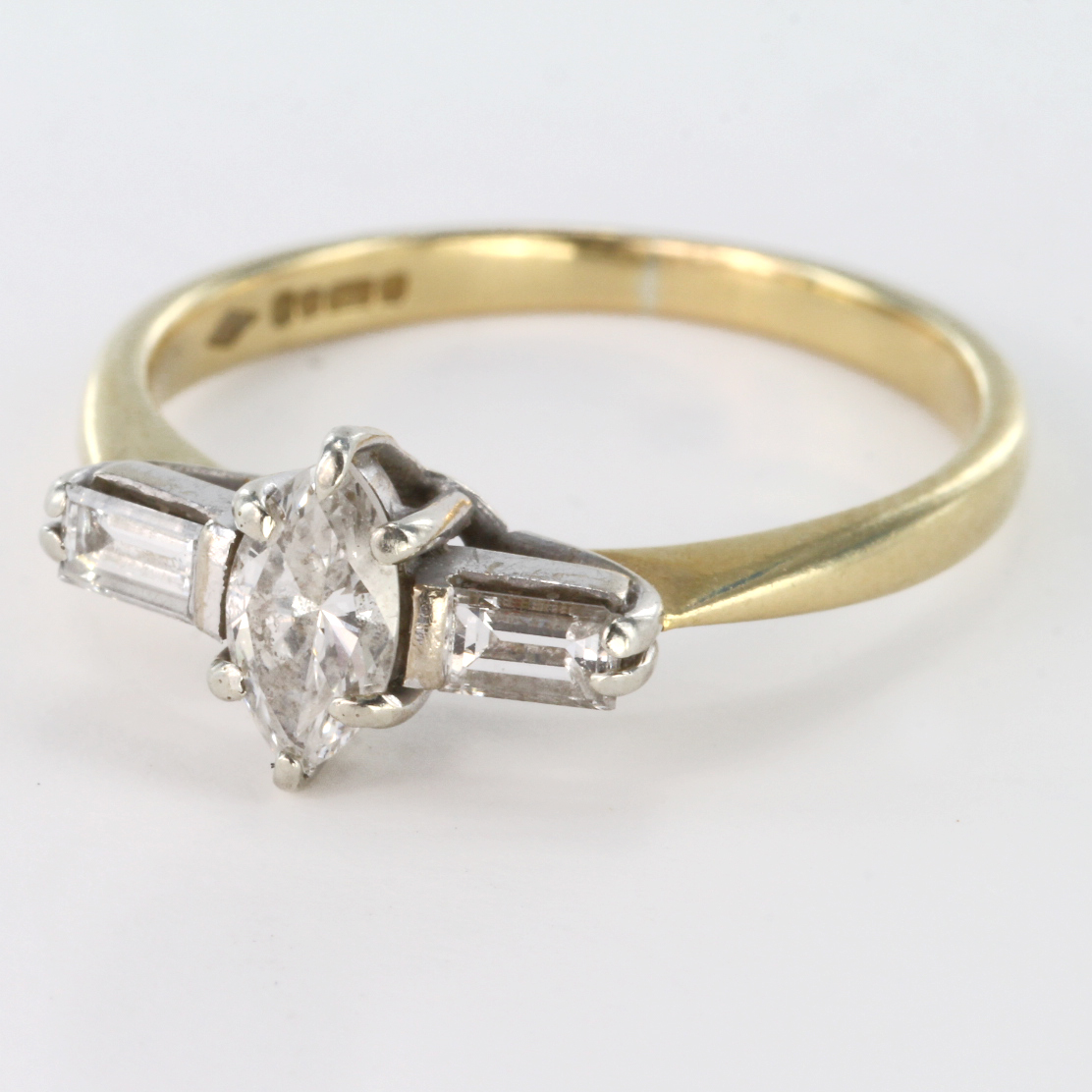 18ct gold ring set with central Marquis cut diamond stone plus two baguette cut diamonds either