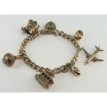 9ct charm bracelet with a small selection of charms attached. Total weight 32.1g