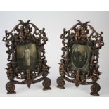 Pair of cast iron photograph frames with cherub decoration, 36.5cm x 23cm approx.