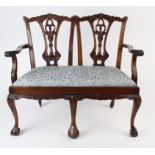 Small mahogany five legged settee with carved decoration, circa early 20th century, one leg in