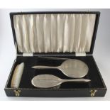 Boxed silver backed dressing table set hallmarked for B & Co., Birm. 1970/71.