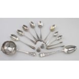 Mixed lot of silver flatware includes tea strainer, child’s spoon, 2 silver thimbles etc. Weight