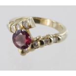 Ladies 14kt dress ring, with a central 7mm Ruby in a crossover setting, each side set with four