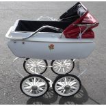 Tri-ang 1960s Dolls Pram, finished in white with floral decal, blue interior red canvas hood and