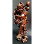Chinese root carved figure of a sage holding a peach branch and a sackful of peaches, bone inset
