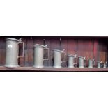 Set of eight French pewter graduated cylindrical lidded measures, the largest two litres, height