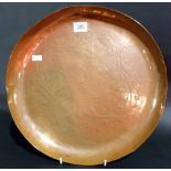 Newlyn copper circular tray embossed with four leaves, stamped mark, diameter 13'.