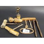 Four various cork screws, a nut cracker and two wine bottle stoppers