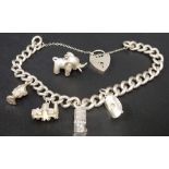 Silver curb link bracelet with padlock clasp together with four various charms