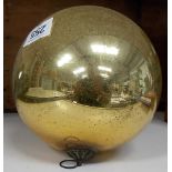 A large gold glass witch ball, diameter 6'.