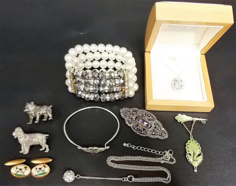 Tin of costume jewellery inc. a silver filigree amethyst brooch etc