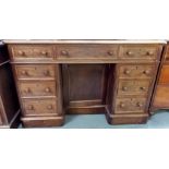 Victorian mahogany kneehole desk, the moulded top over an arrangement of nine drawers, the recess