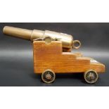 Bronze table cannon upon an oak carriage with bronze wheels, length of cannon 9.25'