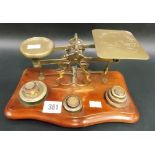 Brass postal balance scales with 9 stacking weights.