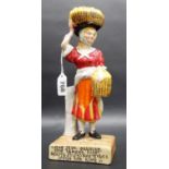 A rare Clarice Cliff Wilkinson Ltd figure of a lady with a basket or oranges on her head, the base