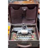 A Blick aluminium featherweight typewriter within tan leather case.
